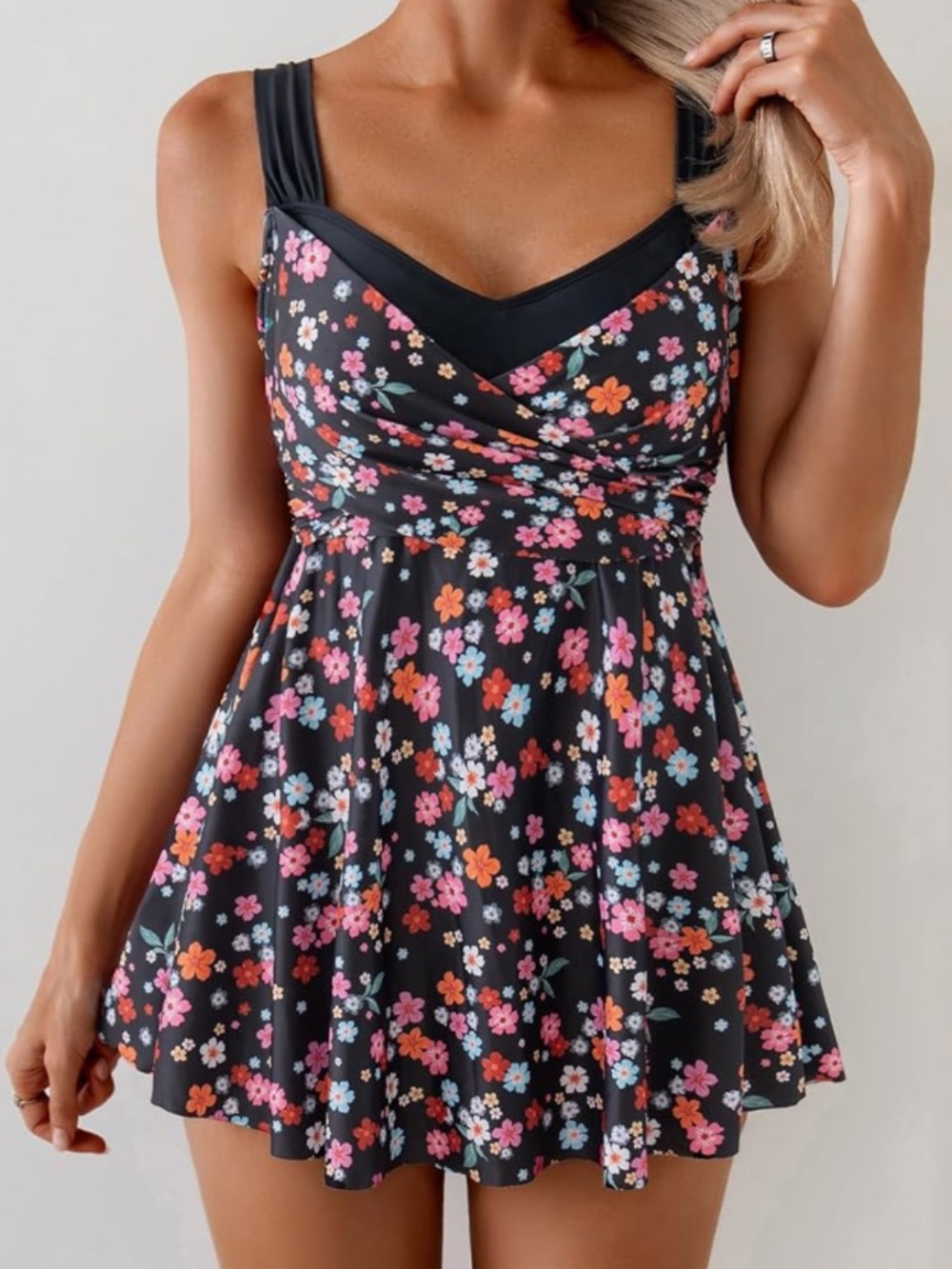 Flattering swim dress with a ditsy floral print. Features pink, coral-orange and